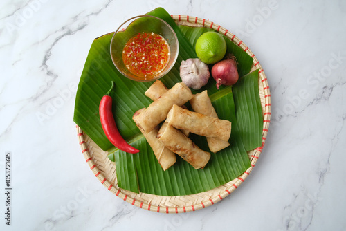 Freshly cooked Filipino food called Lumpiang Shanghai or fried pork spring rolls. photo