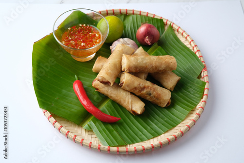 Freshly cooked Filipino food called Lumpiang Shanghai or fried pork spring rolls. photo