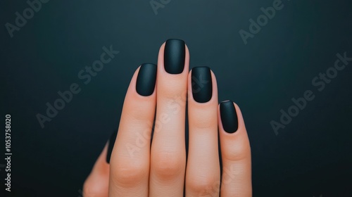 Sleek matte black manicured nails with a modern and edgy look captured in a deep depth of field for a premium high end aesthetic photo