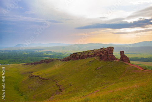 Summer landscape of the Sunduki mountain range against sunset sky in Khakassia, Russia. Located in the valley of the Bely Iyus River. photo