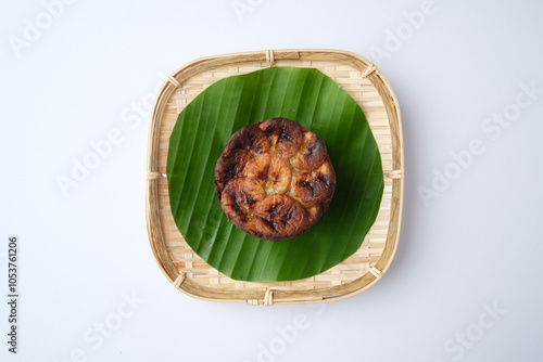 Banh Chuoi Nuong served on a banana leaf in a woven plate. photo