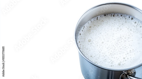 A close-up view of a stainless steel sink filled with soapy water and foam near the drain, highlighting its sleek metallic surface