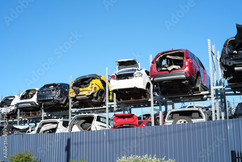 A multi-level car storage structure filled with various damaged vehicles
