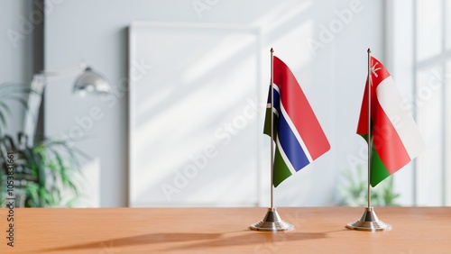 FLAGS OF GAMBIA AND OMAN ON TABLE photo