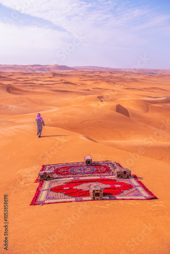 Fototapeta Naklejka Na Ścianę i Meble -  Woman posing background red dunes of Saudi Arabia