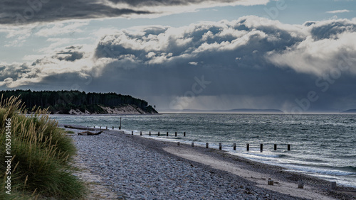 Strand bei Findhorn mit dramatischer Wolkenstimmung, Regen im Hintergrund, Dünengras im Vordergrund photo