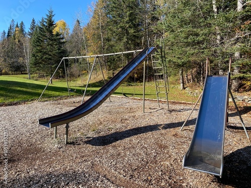 Vintage playground equipment, including metal slides and swings.