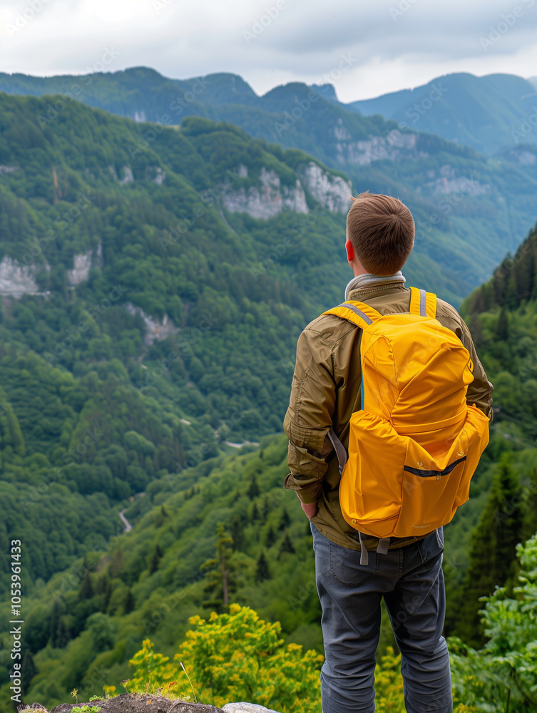 Man with Yellow Backpack Overlooking Mountain Landscape Man with Yellow Backpack Overlooking Mountain Landscape