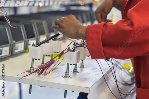 auto harness wiring factory panel, car electric harnesses factory ,panel with wires tubing and connectors, african american worker