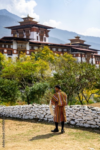 Man in traditional Bhutanese attire at Punakha Dzong. photo