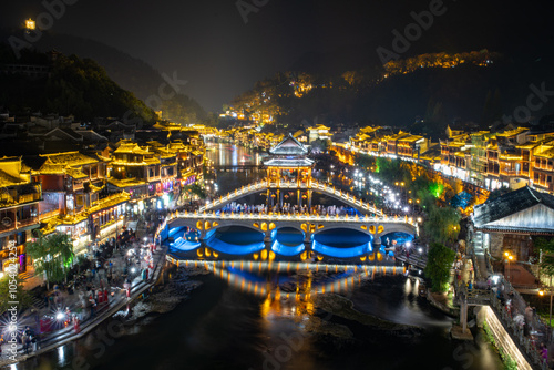 Canvas Print Chinese tourist attraction destination - Feng Huang Ancient Town (Phoenix Ancient Town) on Tuo Jiang River illuminated at night