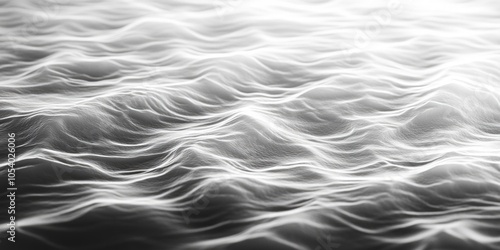 The image is a black and white photo of a wave in the ocean. The water appears to be choppy and rough, with a sense of movement and energy. The image evokes a feeling of power and strength