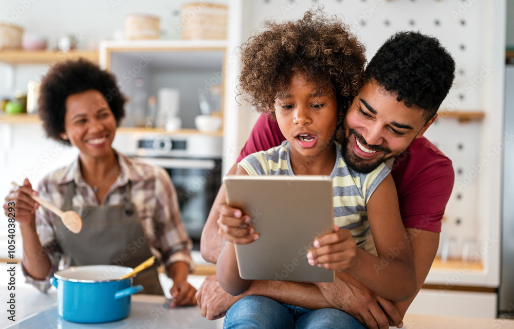Fototapeta premium Happy african family having fun with device at home. Black parents and child using digital tablet