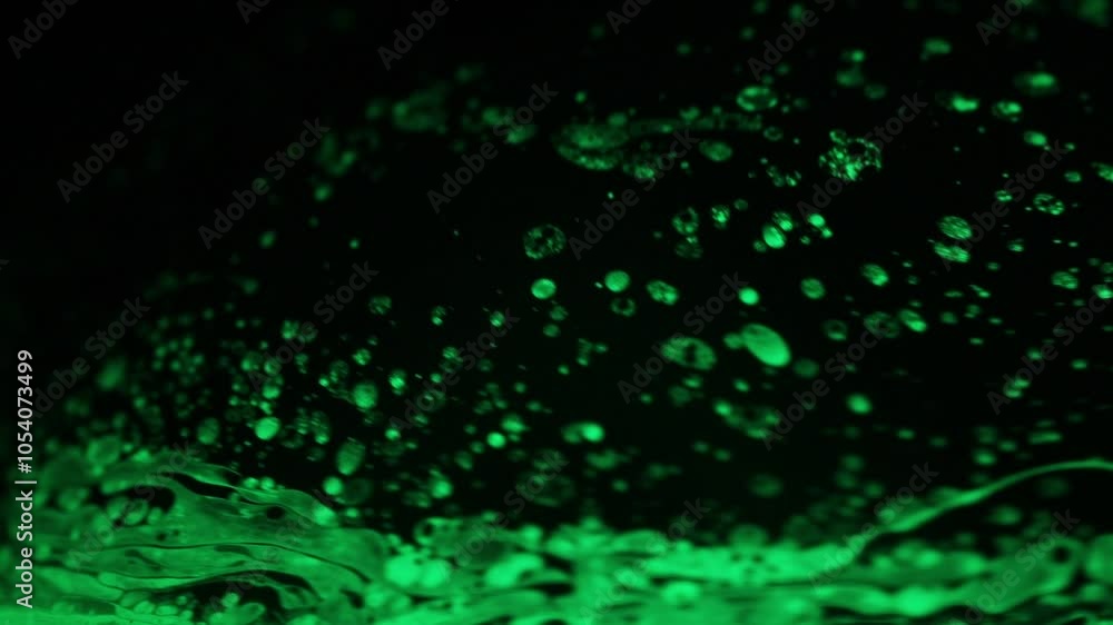 Green spotted liquid, bright warm light, fluid abstraction, Natural background, bright dots on dark backgroun, natural particles, transparent water surface Green spotted liquid, bright warm light, fluid abstraction, Natural background, bright dots on dark backgroun, natural particles, transparent water surface