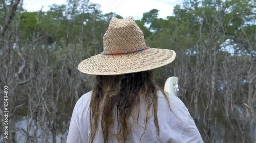 Follow Shot of a Woman Walking with a Surf Board at Swamp Wood Bridge