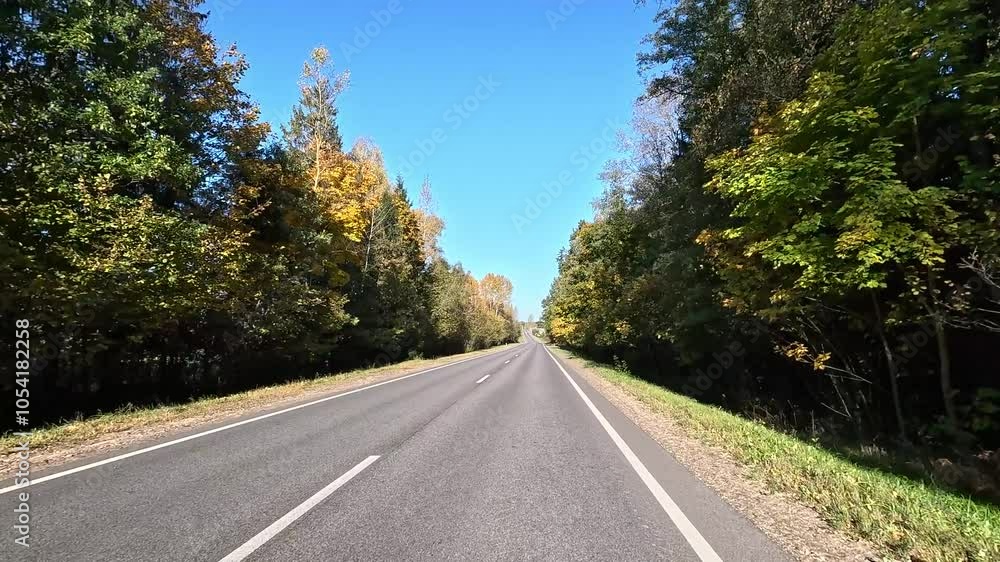 Highways, roadside and road line markings. The car drives along the road on a summer day. Highways, roadside and road line markings. The car drives along the road on a summer day.