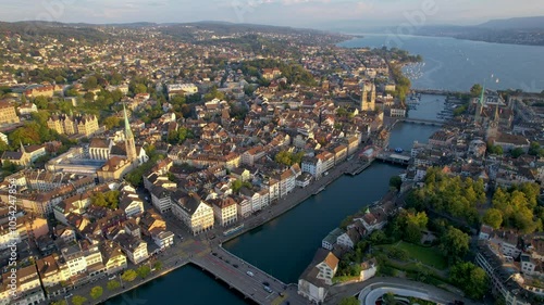 Beautiful aerial footage of the city of Zurich in Switzerland - the Limmat River and its iconic churches, buildings rivers and Clockes.