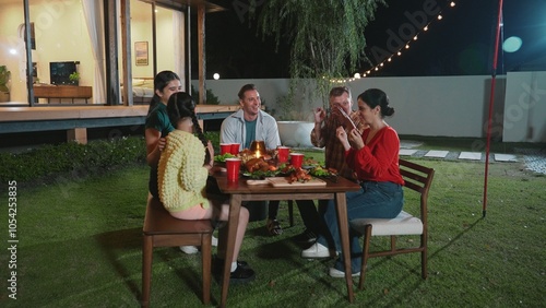 Family gather celebrate holiday. Parents, grandparents and girl together to talk and have dinner party food. Outdoor activity for spending time with multigeneration cross generation gap. Divergence.