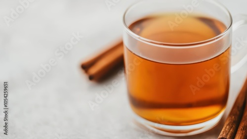 Aromatic hot cider steaming in a glass, cinnamon sticks and cloves adding fragrance, hot cider, drink aroma