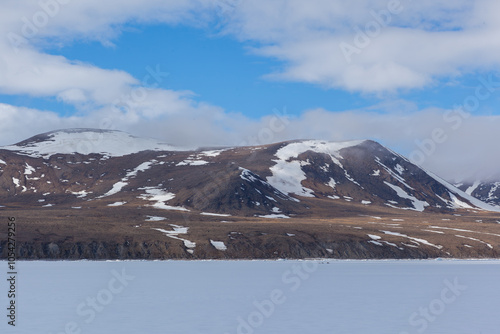 Snow-Capped Alaskan Mountains Under Blue Sky in Winter