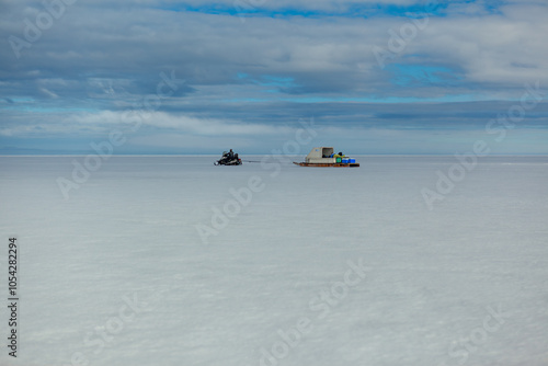 Remote Snowmobile Journey Across Expansive Arctic Landscape