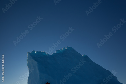 Majestic Iceberg Against a Clear Blue Arctic Sky