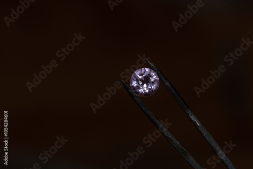 close up photo of round Diamond in Tweezers photo