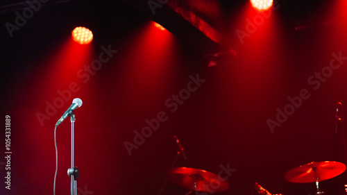 Background - microphone on stage against red spotlights, no people