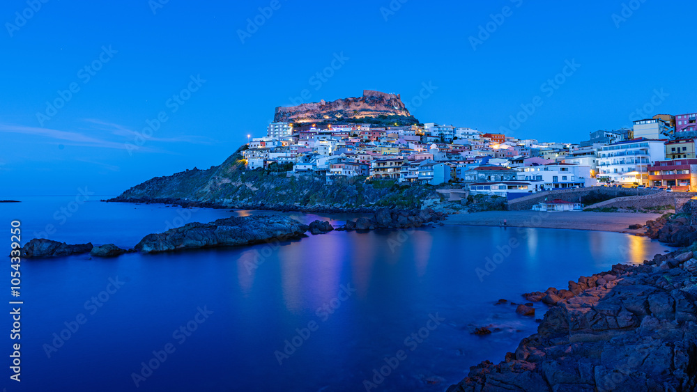 Fototapeta premium Picturesque panoramic view of medieval town of Castelsardo at night, during the blue hour, Province of Sassari, Sardinia, Italy, Europe.