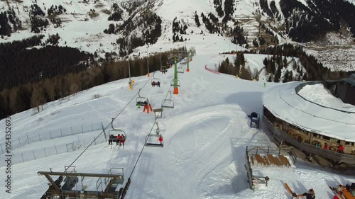 Ski lifts, chair lift for skiers on the move. Chair lifts and cable cars at Passo Brocon. Winter time. photo