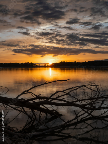 Landscape of a lake with the reflection of the mountains and clouds at autumn sunset in Granada (Spain) photo