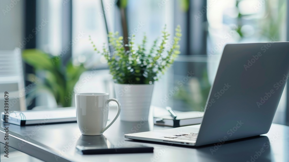 Sleek modern office desk with a laptop, coffee mug, and stationery Sleek modern office desk with a laptop, coffee mug, and stationery