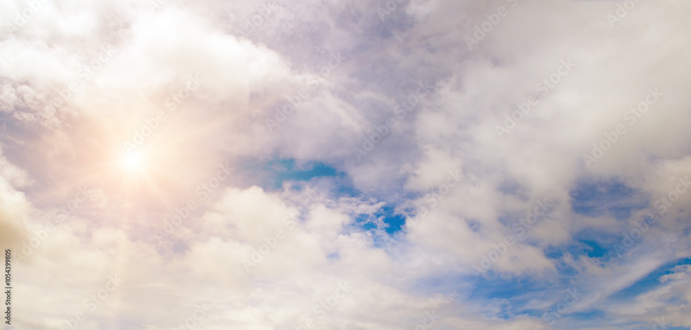 Obraz premium Blue sky with white clouds and bright sun.