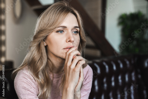 Tired upset Caucasian woman worried about tiredness from domestic work sitting at couch. Frustrating mom stressful feels heaviness and headache at home. Fatigue parent trying relaxing in living room. photo