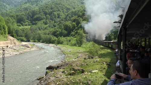 Viseu de Sus, Romania - June 05, 2017: Tourists enjoy the trip in steam train through the mountains in Maramures