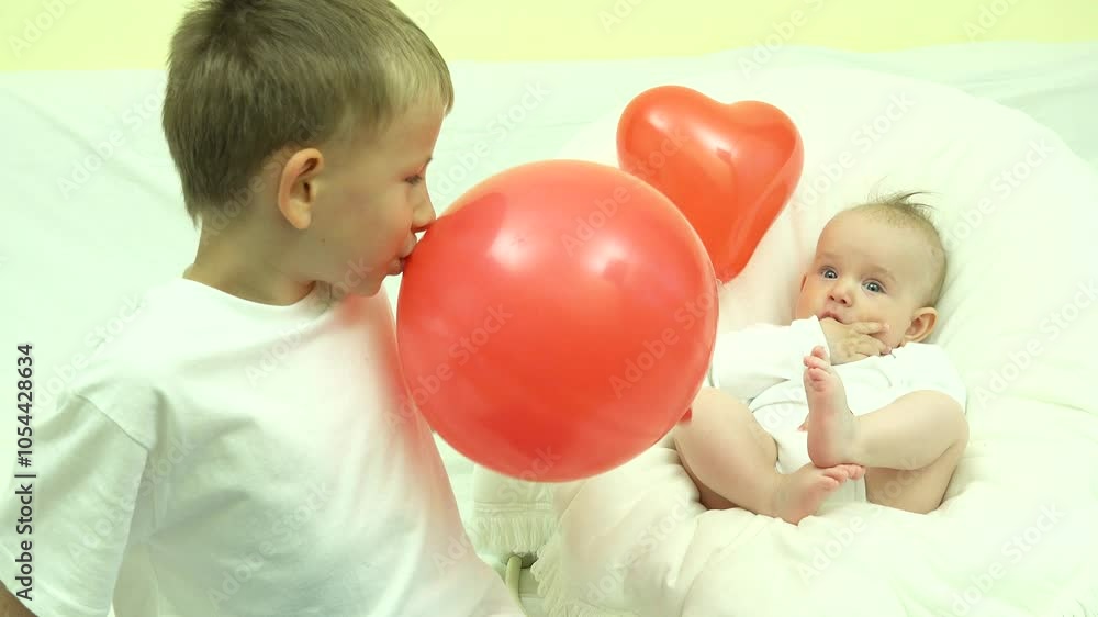 Bog and small brothers playing with red balloons Bog and small brothers playing with red balloons