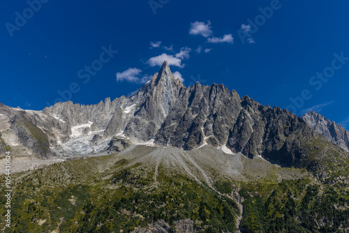 Wallpaper Mural The Petit Dru mountain summit displays rugged peaks and rocky formations against clear sky. Rocky peak of Aiguilles de Dru, les Drus in Chamonix Alps Torontodigital.ca