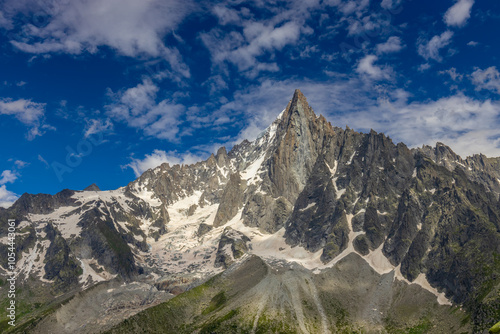 The Petit Dru mountain summit displays rugged peaks and rocky formations against clear sky. Rocky peak of Aiguilles de Dru, les Drus in Chamonix Alps photo