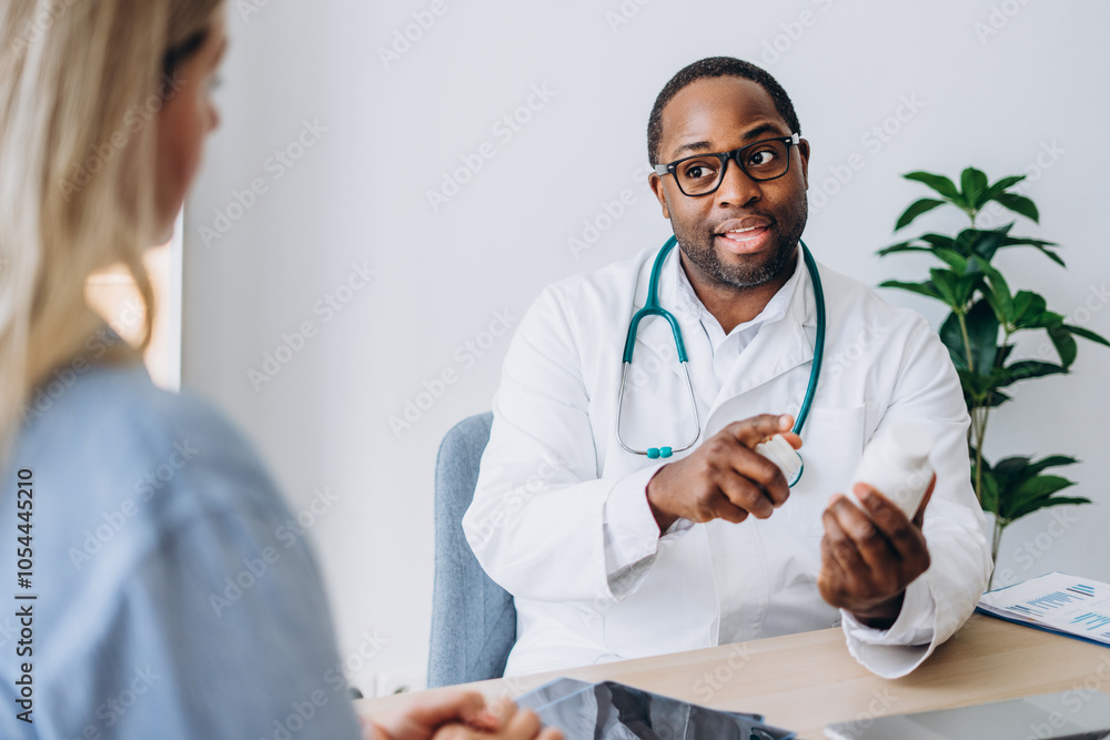 Fototapeta premium Male doctor and female patient having medical consultation prescribe pills at clinic