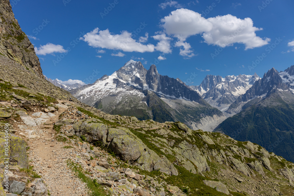 The Petit Dru mountain summit displays rugged peaks and rocky formations against clear sky. Rocky peak of Aiguilles de Dru, les Drus in Chamonix Alps The Petit Dru mountain summit displays rugged peaks and rocky formations against clear sky. Rocky peak of Aiguilles de Dru, les Drus in Chamonix Alps