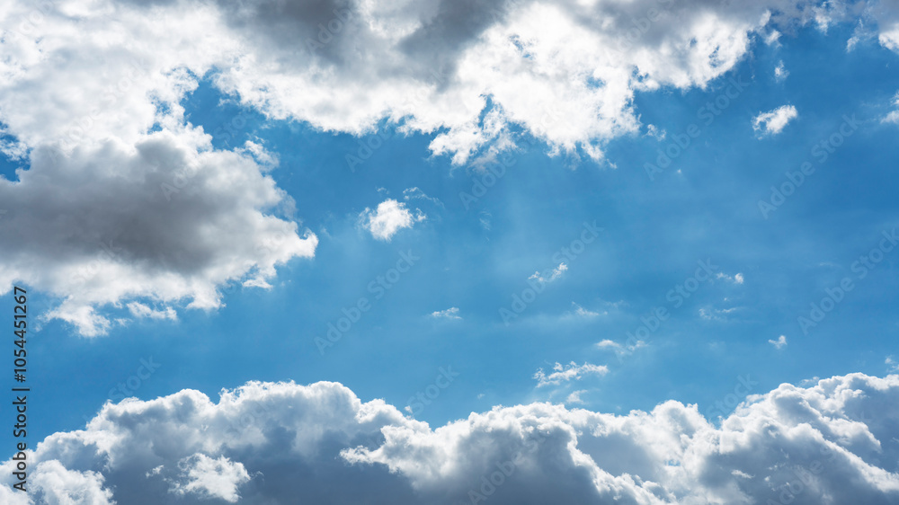 Obraz premium Background of backlit Cumulus white clouds bodies floating in clear blue sky
