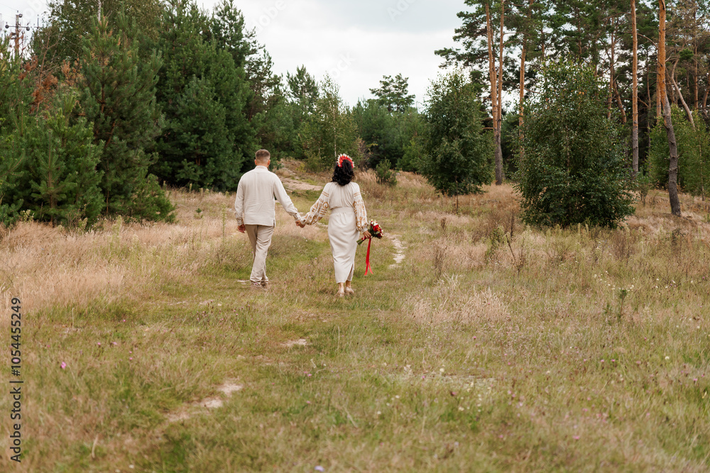 Romantic Couple Walking Hand in Hand Through Enchanted Forest Pathway Romantic Couple Walking Hand in Hand Through Enchanted Forest Pathway