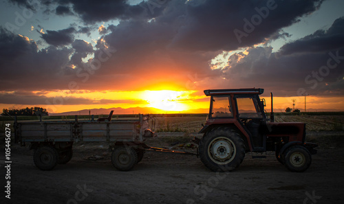 magnificent sunset and tractor view in agricultural field