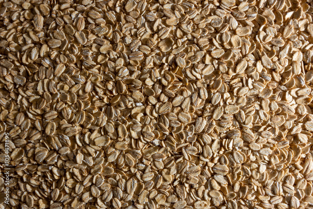 Uncooked Oat Flakes background - Top View, Flat Lay. Scattered Dry and Raw Oat Flakes. Healthy Breakfast and Diet Eating Ingredients Uncooked Oat Flakes background - Top View, Flat Lay. Scattered Dry and Raw Oat Flakes. Healthy Breakfast and Diet Eating Ingredients