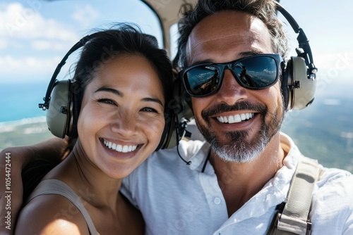 An exhilarated couple enjoying a thrilling helicopter ride, capturing an unforgettable sky adventure characterized by joy, beauty, and the spirit of freedom. photo