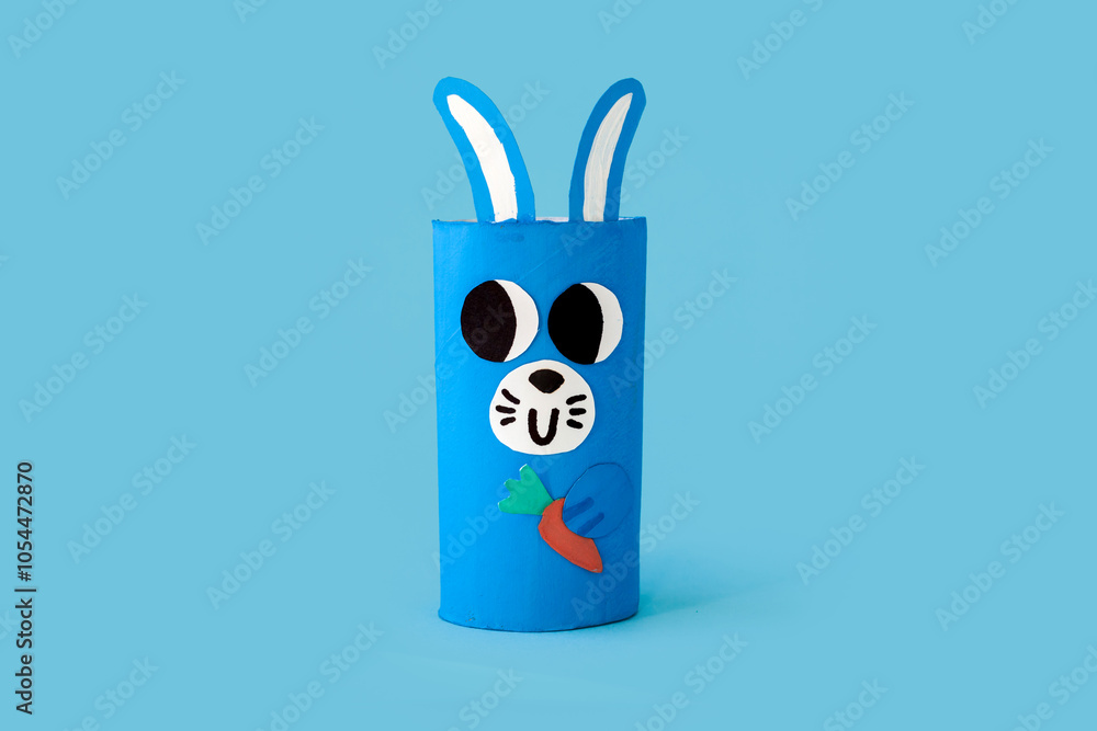 Christmas and Easter toy from toilet tube roll, paper rabbit on blue background. Holiday easy kids DIY, decoration idea for winter ans spring season. Children's crafts Christmas and Easter toy from toilet tube roll, paper rabbit on blue background. Holiday easy kids DIY, decoration idea for winter ans spring season. Children's crafts