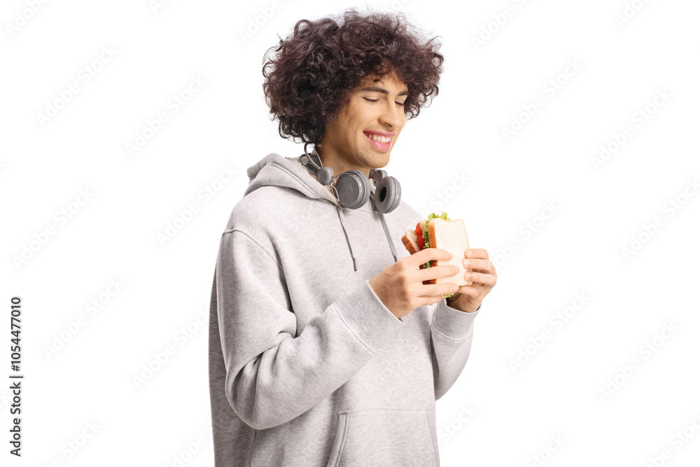 Happy young man with headphones holding a sandwich Happy young man with headphones holding a sandwich