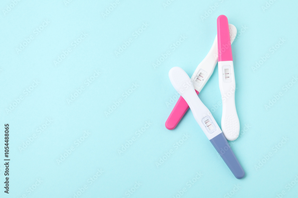 Pregnancy tests on light blue background, top view. Space for text Pregnancy tests on light blue background, top view. Space for text