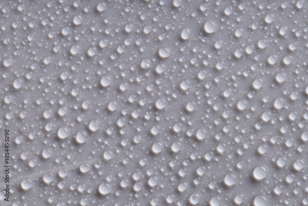 Fototapeta premium Water drops on gray background, top view