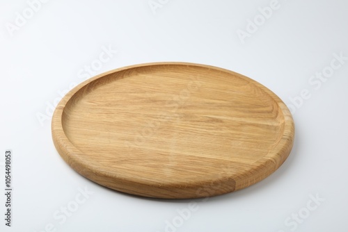 One wooden plate on white background. Tableware